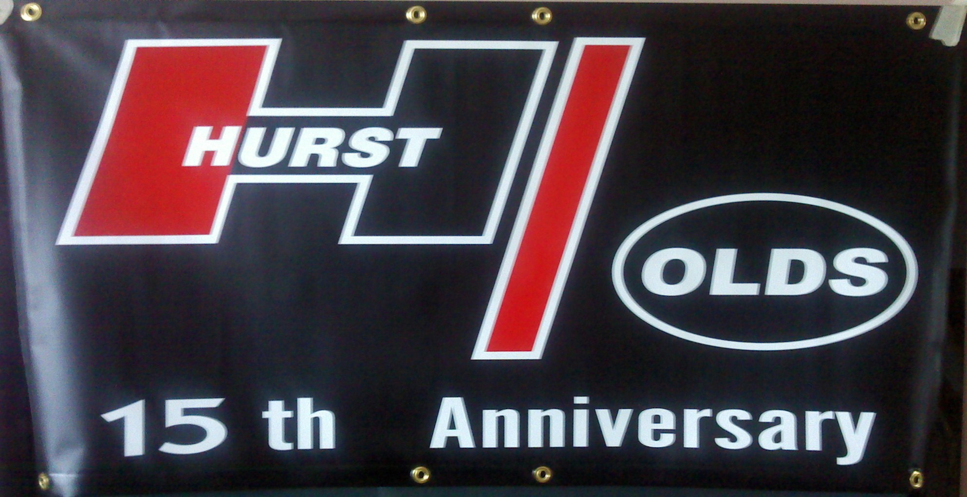 Hurst Olds 15th Anniversary premium 13 oz vinyl banner, black with red, black and silver lettering 2 FT x 4 FT